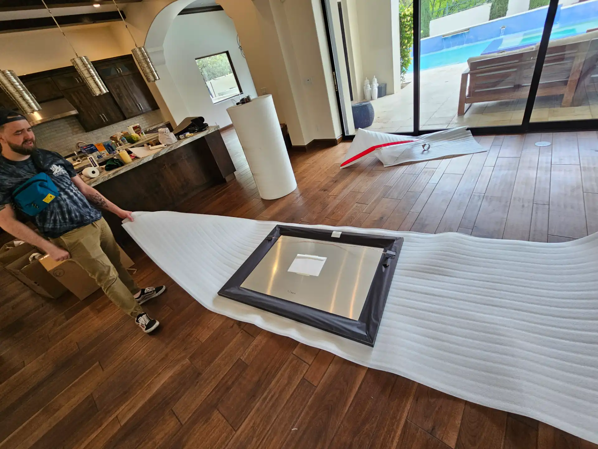 Framed artwork being wrapped in protective padding at a client's home